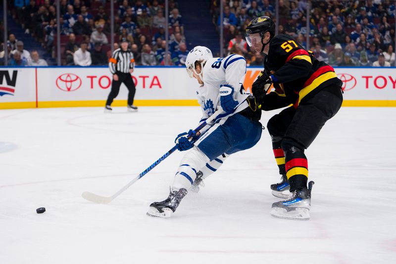 Jan 20, 2024; Vancouver, British Columbia, CAN; Vancouver Canucks defenseman Tyler Myers (57) checks Toronto Maple Leafs forward William Nylander (88) in the second period at Rogers Arena. Mandatory Credit: Bob Frid-USA TODAY Sports