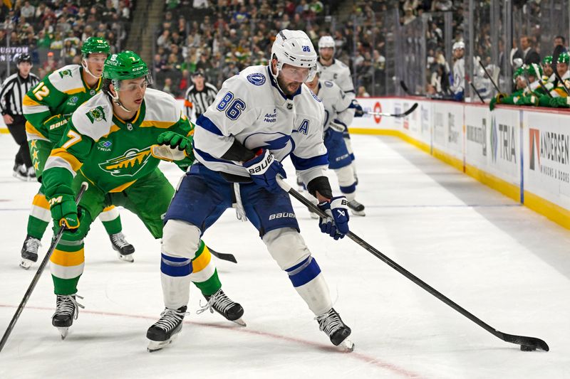 Nov 1, 2024; Saint Paul, Minnesota, USA;  Tampa Bay Lightning forward Nikita Kucherov (86) protects the puck from Minnesota Wild defenseman Brock Faber (7) during the third period at Xcel Energy Center. Mandatory Credit: Nick Wosika-Imagn Images