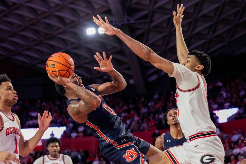 Jan 4, 2023; Athens, Georgia, USA; Auburn Tigers guard K.D. Johnson (0) tries to shoot against Georgia Bulldogs center Frank Anselem (5) during the first half at Stegeman Coliseum. Mandatory Credit: Dale Zanine-USA TODAY Sports