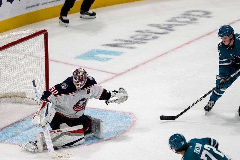 Nov 5, 2024; San Jose, California, USA;  Columbus Blue Jackets goaltender Elvis Merzlikins (90) makes a save against San Jose Sharks left wing William Eklund (72) during overtime at SAP Center at San Jose. Mandatory Credit: Neville E. Guard-Imagn Images