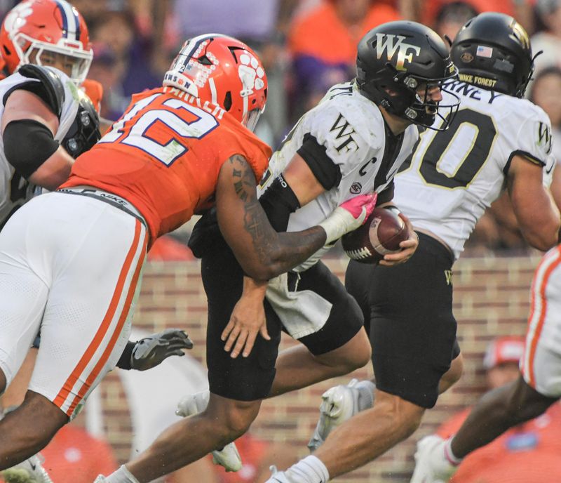 Oct 7, 2023; Clemson, South Carolina, USA; Clemson Tigers defensive lineman T.J. Parker (12) sacks Wake Forest Demon Deacons quarterback Mitch Griffis (12) during the fourth quarter at Memorial Stadium. Mandatory Credit: Ken Ruinard-USA TODAY Sports