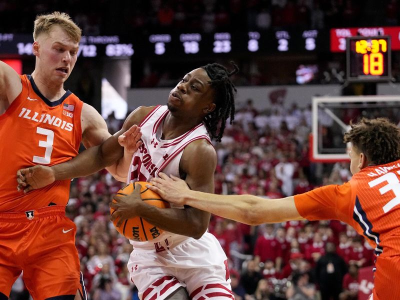 Mar 2, 2024; Madison, WI, USA;  Wisconsin guard John Blackwell (25) is fouled by Illinois forward Coleman Hawkins (33) during the second half of their game Saturday, March 2, 2024 at the Kohl Center in Madison, Wisconsin.  Mandatory Credit: Mark Hoffman-USA TODAY Sports
