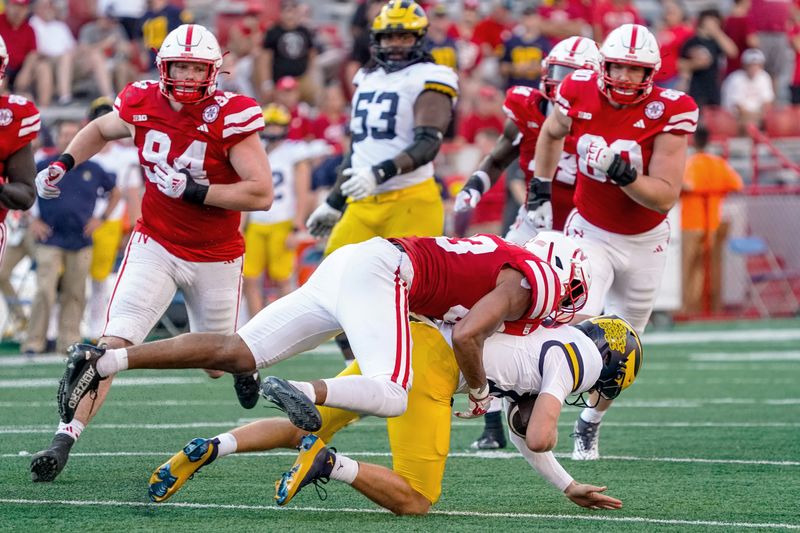 Sep 30, 2023; Lincoln, Nebraska, USA; Nebraska Cornhuskers linebacker Javin Wright (33) tackles Michigan Wolverines quarterback Davis Warren (16) during the fourth quarter at Memorial Stadium. Mandatory Credit: Dylan Widger-USA TODAY Sports