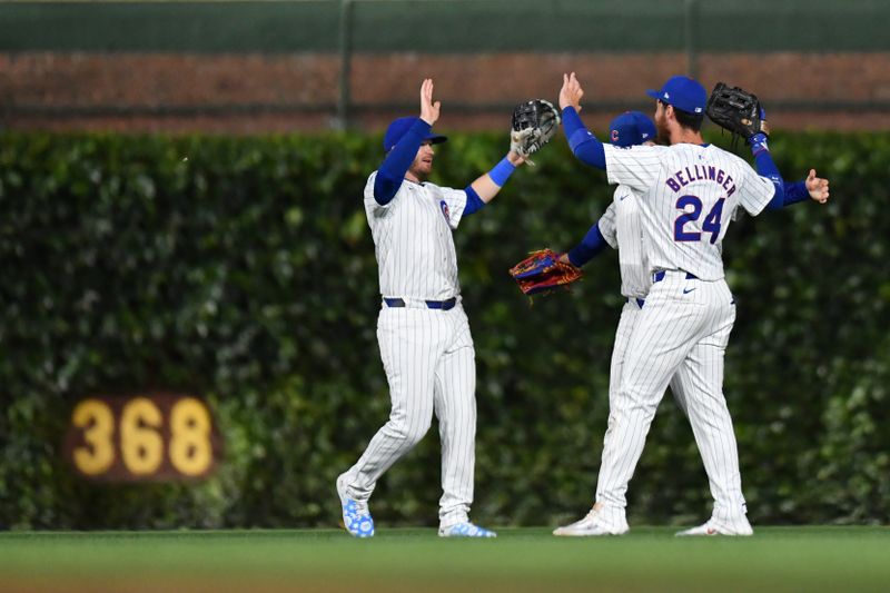 Aug 20, 2024; Chicago, Illinois, USA; Chicago Cubs left fielder Ian Happ (left), center fielder Pete Crow-Armstrong (behind center), and right fielder Cody Bellinger (right) celebrate after defeating the Detroit Tigers at Wrigley Field. Mandatory Credit: Patrick Gorski-USA TODAY Sports