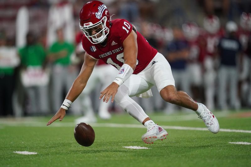 Oct 15, 2022; Fresno, California, USA; Fresno State Bulldogs quarterback Logan Fife (10) recovers a fumble against the San Jose State Spartans in the first quarter at Valley Children's Stadium. Mandatory Credit: Cary Edmondson-USA TODAY Sports