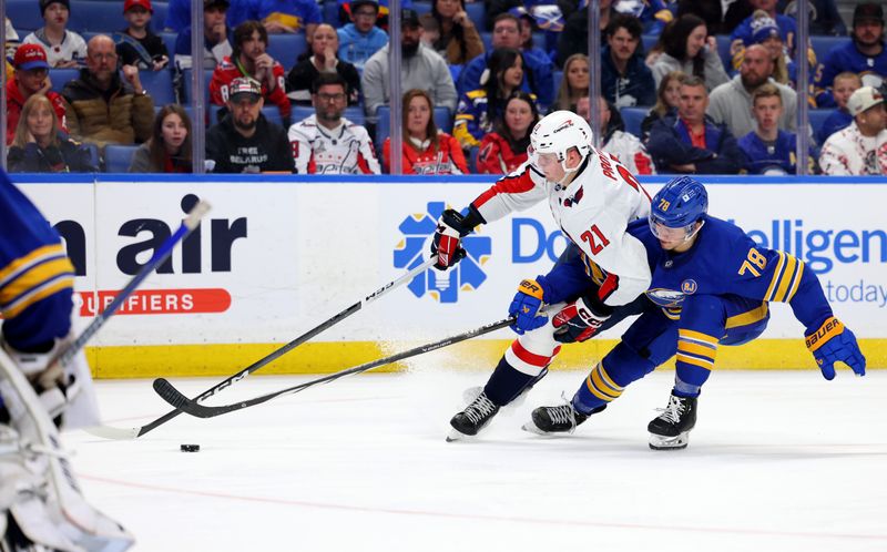 Apr 11, 2024; Buffalo, New York, USA;  Washington Capitals center Aliaksei Protas (21) skates with the puck as Buffalo Sabres defenseman Jacob Bryson (78) defends during the third period at KeyBank Center. Mandatory Credit: Timothy T. Ludwig-USA TODAY Sports