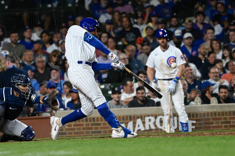 May 30, 2023; Chicago, Illinois, USA;  Chicago Cubs left fielder Mike Tauchman (40) hits an RBI single against the Tampa Bay Rays during the sixth inning at Wrigley Field. Mandatory Credit: Matt Marton-USA TODAY Sports