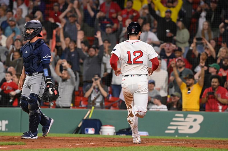 May 14, 2024; Boston, Massachusetts, USA; Boston Red Sox catcher Connor Wong (12)  scores the winning run on an an RBI by shortstop Romy Gonzalez (23) (not pictured) during the twelfth inning against the Tampa Bay Rays at Fenway Park. Mandatory Credit: Eric Canha-USA TODAY Sports