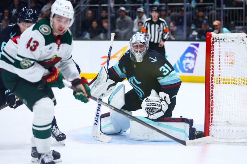 Jan 8, 2026; Seattle, Washington, USA; Seattle Kraken goalie Philipp Grubauer (31) tracks the puck in the third period against the Minnesota Wild at Climate Pledge Arena. Mandatory Credit: Kevin Ng-Imagn Images
