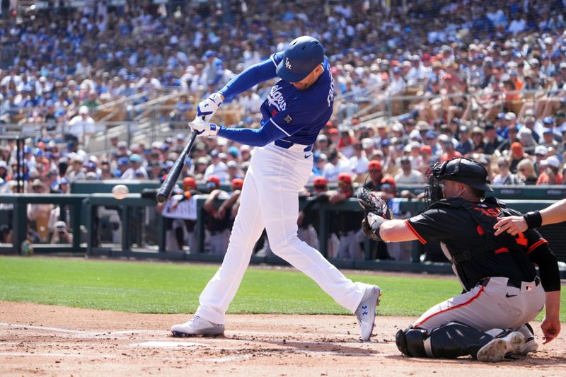 Mar 1, 2025; Phoenix, Arizona, USA; Los Angeles Dodgers first base Freddie Freeman (5) bats against the San Francisco Giants during the first inning at Camelback Ranch-Glendale. Mandatory Credit: Joe Camporeale-Imagn Images