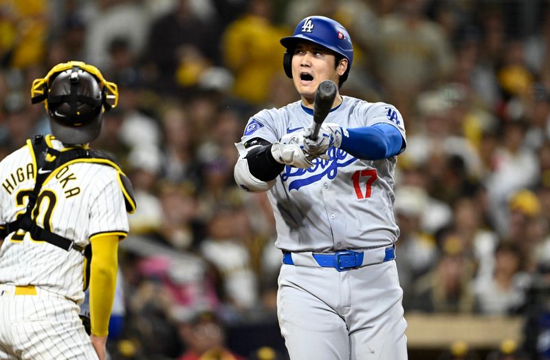 Oct 9, 2024; San Diego, California, USA; Los Angeles Dodgers designated hitter Shohei Ohtani (17) reacts after a foul ball in the sixth inning against the San Diego Padres during game four of the NLDS for the 2024 MLB Playoffs at Petco Park.  Mandatory Credit: Denis Poroy-Imagn Images