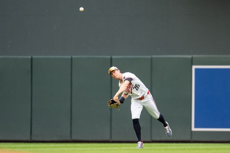 Jul 4, 2024; Minneapolis, Minnesota, USA; Minnesota Twins outfielder Max Kepler (26) throws the ball after fielding a ball hit by Detroit Tigers third base Gio Urshela (13) in the second inning at Target Field. Mandatory Credit: Matt Blewett-USA TODAY Sports