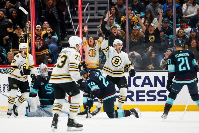 Feb 26, 2024; Seattle, Washington, USA; Boston Bruins center Charlie Coyle (13, second from right) celebrates after scoring a goal against Seattle Kraken goaltender Philipp Grubauer (31, second from left) during the third period at Climate Pledge Arena. Mandatory Credit: Joe Nicholson-USA TODAY Sports