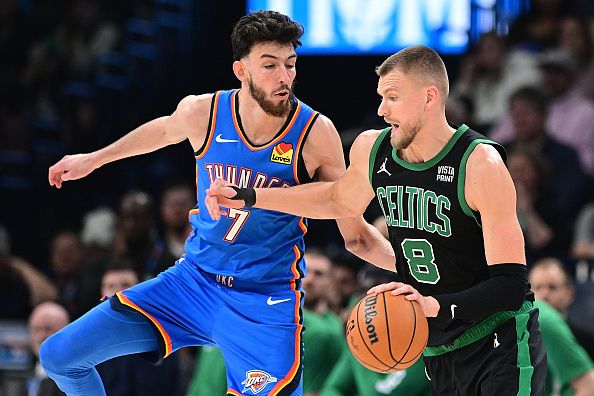 OKLAHOMA CITY, OKLAHOMA - JANUARY 2: Kristaps Porzingis #8 of the Boston Celtics attempts to drive past Chet Holmgren #7 of the Oklahoma City Thunder during the second half at Paycom Center on January 2, 2024 in Oklahoma City, Oklahoma. NOTE TO USER: User expressly acknowledges and agrees that, by downloading and or using this Photograph, user is consenting to the terms and conditions of the Getty Images License Agreement. (Photo by Joshua Gateley/Getty Images)