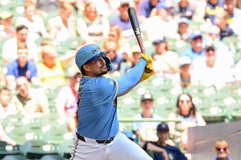 Jul 14, 2024; Milwaukee, Wisconsin, USA; Milwaukee Brewers shortstop Willy Adames (27) hits a double to drive in a run in the first inning against the Washington Nationals at American Family Field. Mandatory Credit: Benny Sieu-USA TODAY Sports