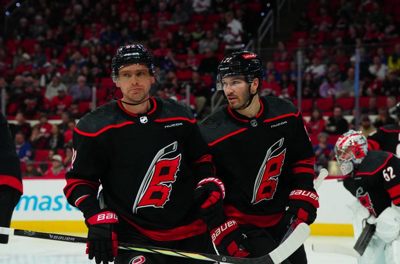 Mar 12, 2024; Raleigh, North Carolina, USA; Carolina Hurricanes center Evgeny Kuznetsov (92) and defenseman Brett Pesce (22) talk against the New York Rangers during the second period at PNC Arena. Mandatory Credit: James Guillory-USA TODAY Sports