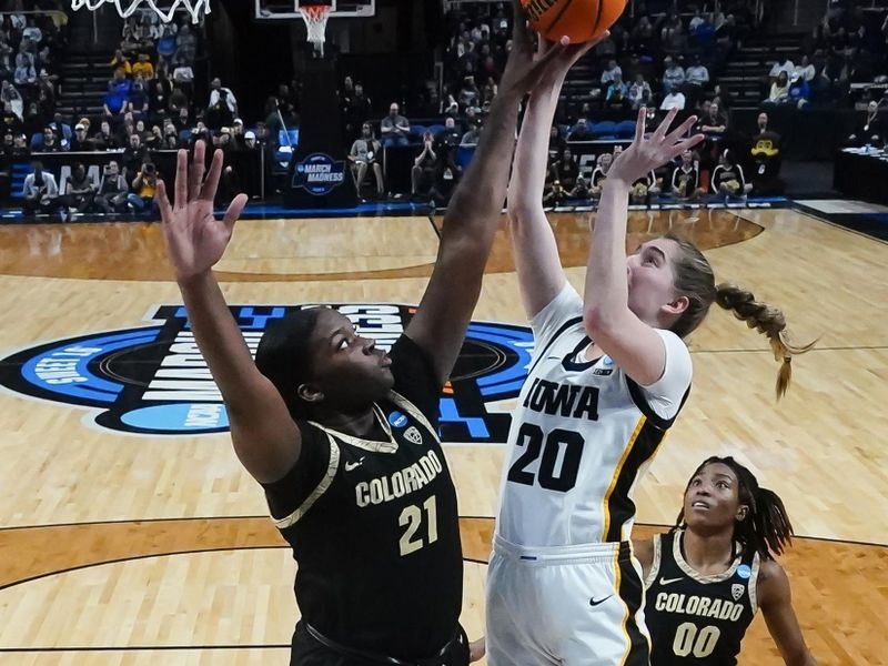 Mar 30, 2024; Albany, NY, USA; Iowa Hawkeyes guard Kate Martin (20) shoots the ball on Colorado Buffaloes center Aaronette Vonleh (21) in the semifinals of the Albany Regional of the 2024 NCAA Tournament at the MVP Arena. Mandatory Credit: Gregory Fisher-USA TODAY Sports