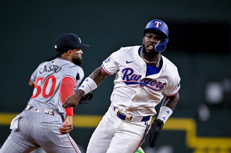 Aug 15, 2024; Arlington, Texas, USA; Texas Rangers right fielder Adolis Garcia (53) runs past Minnesota Twins shortstop Willi Castro (50) during the third inning at Globe Life Field. Mandatory Credit: Jerome Miron-USA TODAY Sports