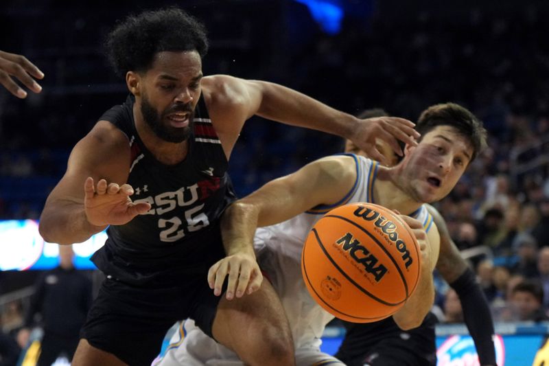 Dec 19, 2023; Los Angeles, California, USA; Cal State Northridge Matadors forward De'Sean Allen-Eikens (25) and UCLA Bruins guard Lazar Stefanovic (10) collide in the second half at Pauley Pavilion presented by Wescom. CSUN defeated UCLA 76-72. Mandatory Credit: Kirby Lee-USA TODAY Sports