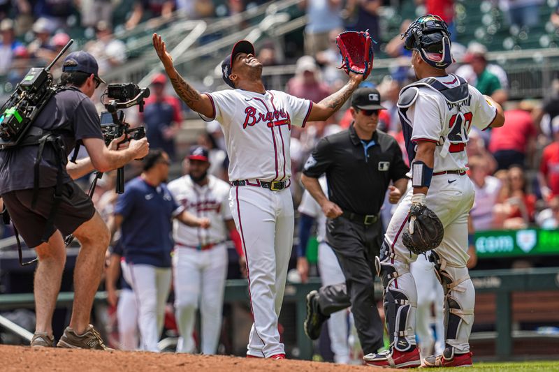 May 15, 2025; Cumberland, Georgia, USA; Atlanta Braves pitcher Raisel Iglesias (26) reacts with catcher Drake Baldwin (30) after the final out against the Washington Nationals during the ninth inning at Truist Park. Mandatory Credit: Dale Zanine-Imagn Images