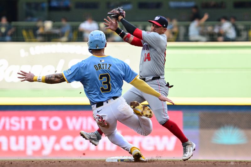 Jul 14, 2024; Milwaukee, Wisconsin, USA; Washington Nationals second baseman Ildemaro Vargas (14) gets ready to tag out Milwaukee Brewers third baseman Joey Ortiz (3) trying to steal second base in the fifth inning at American Family Field. Mandatory Credit: Benny Sieu-USA TODAY Sports