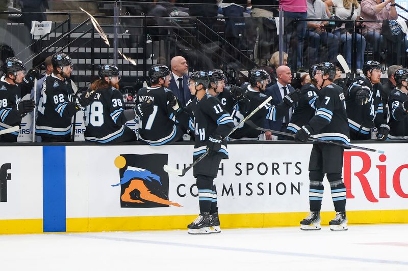 Oct 8, 2024; Salt Lake City, Utah, USA; Utah Hockey Club forward Dylan Guenther (11) celebrates a goal against the Chicago Blackhawks with bench players during the first period at Delta Center. Mandatory Credit: Rob Gray-Imagn Images