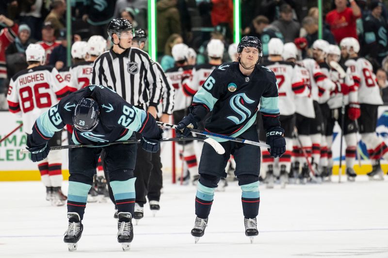 Dec 7, 2023; Seattle, Washington, USA; Seattle Kraken defenseman Vince Dunn (29) and forward Kailer Yamamoto (56) react after a game against New Jersey Devils at Climate Pledge Arena. Mandatory Credit: Stephen Brashear-USA TODAY Sports