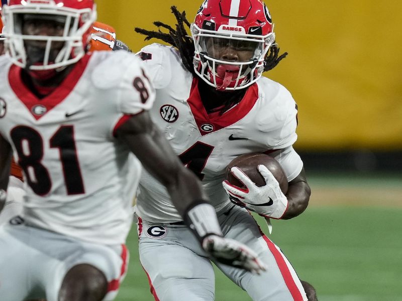 Sep 4, 2021; Charlotte, North Carolina, USA; Georgia Bulldogs running back James Cook (4) follows wide receiver Marcus Rosemy-Jacksaint (81) against the Clemson Tigers during the first quarter at Bank of America Stadium. Mandatory Credit: Jim Dedmon-USA TODAY Sports