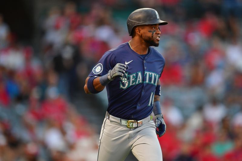 Aug 30, 2024; Anaheim, California, USA; Seattle Mariners right fielder Victor Robles (10) runs after hitting an RBI single against the Los Angeles Angels during the first inning at Angel Stadium. Mandatory Credit: Gary A. Vasquez-USA TODAY Sports