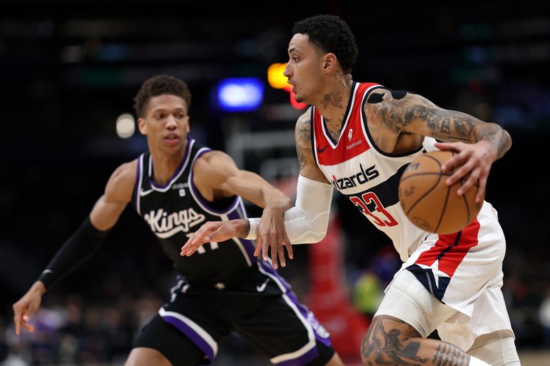 WASHINGTON, DC - MARCH 21: Kyle Kuzma #33 of the Washington Wizards dribbles past Kessler Edwards #17 of the Sacramento Kings during the first half at Capital One Arena on March 21, 2024 in Washington, DC. NOTE TO USER: User expressly acknowledges and agrees that, by downloading and or using this photograph, User is consenting to the terms and conditions of the Getty Images License Agreement. (Photo by Patrick Smith/Getty Images)