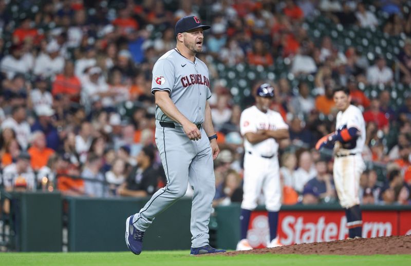 May 1, 2024; Houston, Texas, USA;  Cleveland Guardians manager Stephen Vogt (12) walks to the mound for a pitching change during the eighth inning against the Houston Astros at Minute Maid Park. Mandatory Credit: Troy Taormina-USA TODAY Sports