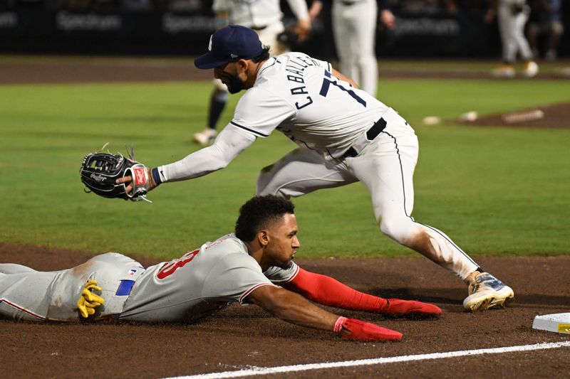 May 8, 2025; St. Petersburg, Florida, USA; Philadelphia Phillies pinch runner Johan Rojas (23) slides into  third base as Tampa Bay Rays third baseman Jose Caballero (77) waits for the ball in the ninth inning  at George M. Steinbrenner Field. Mandatory Credit: Jonathan Dyer-Imagn Images
