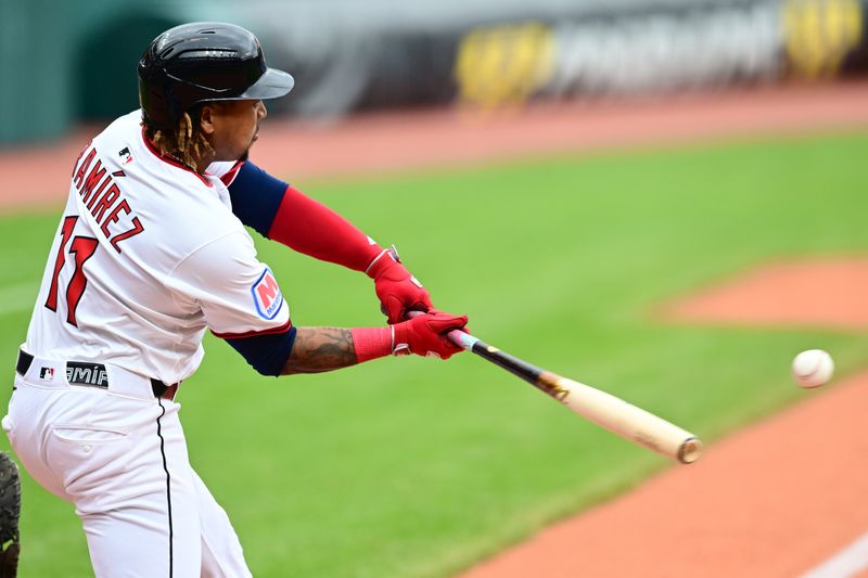 May 28, 2025; Cleveland, Ohio, USA; Cleveland Guardians designated hitter Jose Ramirez (11) hits an RBI single during the first inning against the Los Angeles Dodgers at Progressive Field. Mandatory Credit: Ken Blaze-Imagn Images