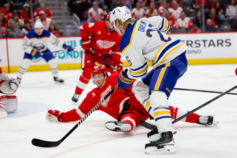 Mar 16, 2024; Detroit, Michigan, USA;  Buffalo Sabres defenseman Rasmus Dahlin (26) skates with the puck defended by Detroit Red Wings defenseman Moritz Seider (53) in the second period at Little Caesars Arena. Mandatory Credit: Rick Osentoski-USA TODAY Sports