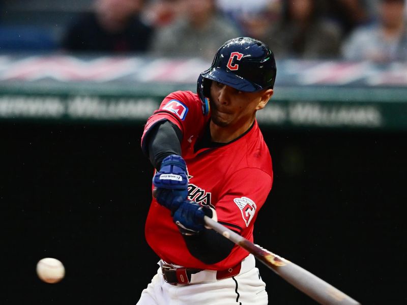Sep 28, 2024; Cleveland, Ohio, USA; Cleveland Guardians second baseman Andres Gimenez (0) hits a single during the second inning against the Houston Astros at Progressive Field. Mandatory Credit: Ken Blaze-Imagn Images