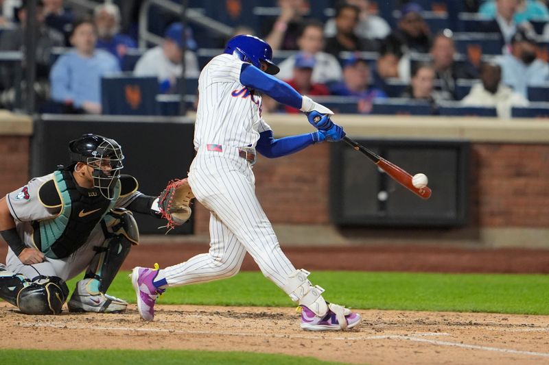 Apr 30, 2025; New York City, New York, USA; New York Mets shortstop Francisco Lindor (12) hits a single against the Arizona Diamondbacks during the fifth inning at Citi Field. Mandatory Credit: Gregory Fisher-Imagn Images