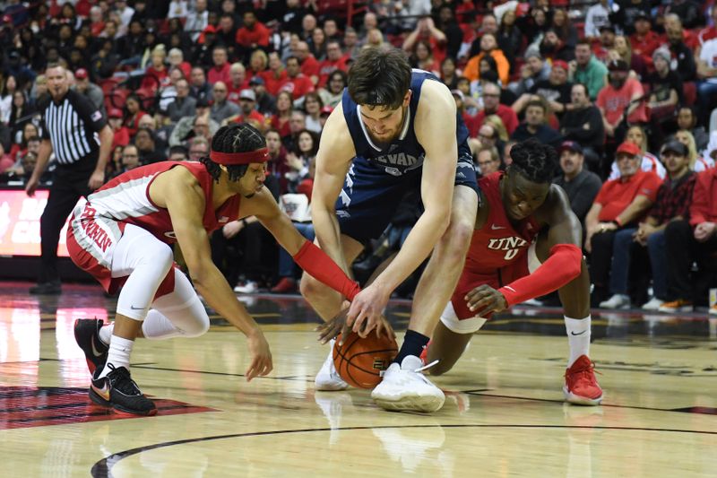 Jan 28, 2023; Las Vegas, Nevada, USA; UNLV Runnin' Rebels guard Justin Webster (2) and forward Victor Iwuakor (0) battle for the ball with Nevada Wolf Pack guard Daniel Foster (20) in the second half at Thomas & Mack Center. Mandatory Credit: Candice Ward-USA TODAY Sports