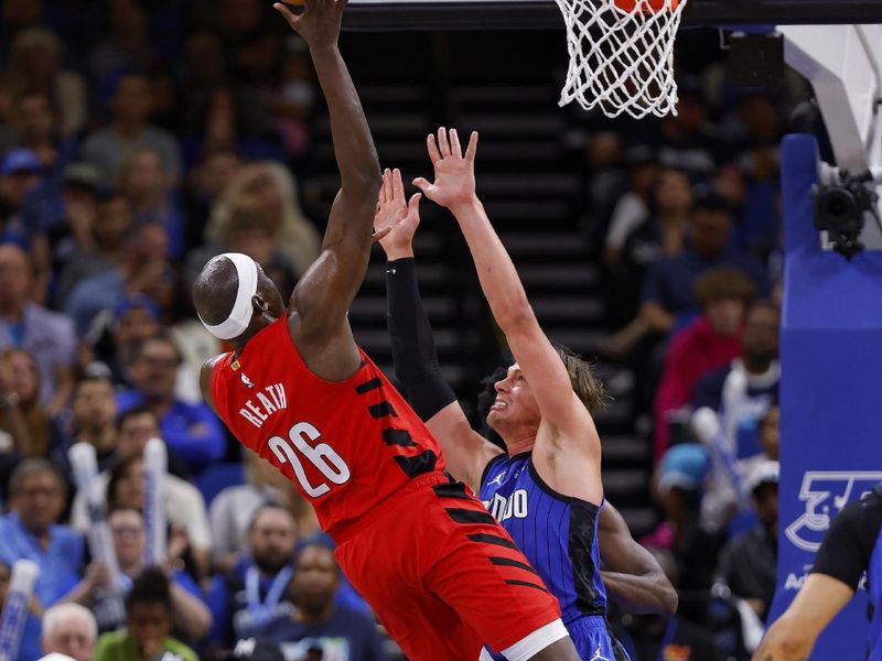 ORLANDO, FLORIDA - APRIL 01: Duop Reath #26 of the Portland Trail Blazers drives to the basket on Franz Wagner #22 of the Orlando Magic during a game  at Kia Center on April 01, 2024 in Orlando, Florida. NOTE TO USER: User expressly acknowledges and agrees that, by downloading and or using this photograph, User is consenting to the terms and conditions of the Getty Images License Agreement. (Photo by Mike Ehrmann/Getty Images)