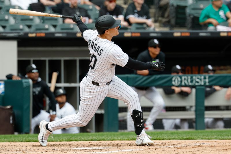 May 1, 2025; Chicago, Illinois, USA; Chicago White Sox third baseman Miguel Vargas (20) hits a three-run home run against the Milwaukee Brewers during the sixth inning at Rate Field. Mandatory Credit: Kamil Krzaczynski-Imagn Images