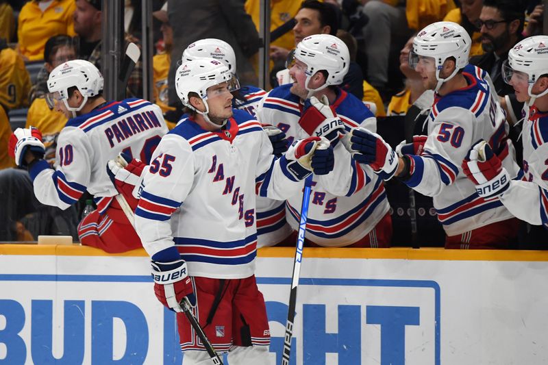 Dec 2, 2023; Nashville, Tennessee, USA; New York Rangers defenseman Ryan Lindgren (55) is congratulated by teammates after a goal during the third period against the Nashville Predators at Bridgestone Arena. Mandatory Credit: Christopher Hanewinckel-USA TODAY Sports