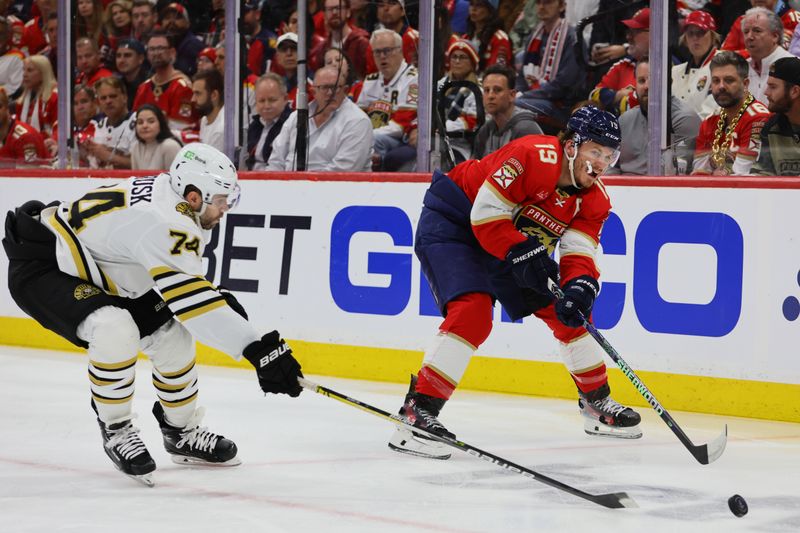 May 8, 2024; Sunrise, Florida, USA; Florida Panthers left wing Matthew Tkachuk (19) moves the puck as Boston Bruins left wing Jake DeBrusk (74) defends during the first period in game two of the second round of the 2024 Stanley Cup Playoffs at Amerant Bank Arena. Mandatory Credit: Sam Navarro-USA TODAY Sports