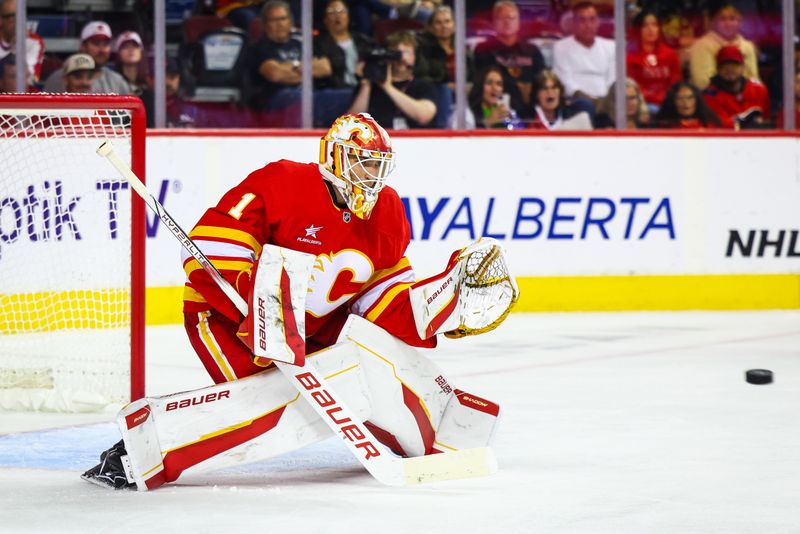 Sep 28, 2024; Calgary, Alberta, CAN; Calgary Flames goaltender Devin Cooley (1) makes a save against the Vancouver Canucks during the third period at Scotiabank Saddledome. Mandatory Credit: Sergei Belski-Imagn Images