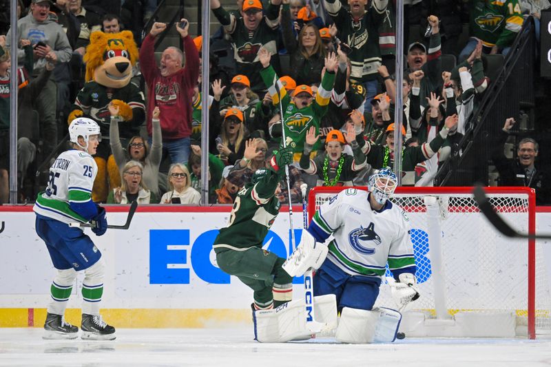 Nov 1, 2025; Saint Paul, Minnesota, USA;  Minnesota Wild forward Vinnie Hinostroza (18) celebrates his goal on Vancouver Canucks goalie Thatcher Demko (35) during the third period at Grand Casino Arena. Mandatory Credit: Nick Wosika-Imagn Images