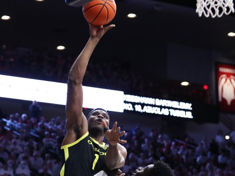 Feb 2, 2023; Tucson, Arizona, USA; Oregon Ducks center N'Faly Dante (1) makes a basket against Arizona Wildcats center Oumar Ballo (11) in the first half at McKale Center. Mandatory Credit: Zachary BonDurant-USA TODAY Sports