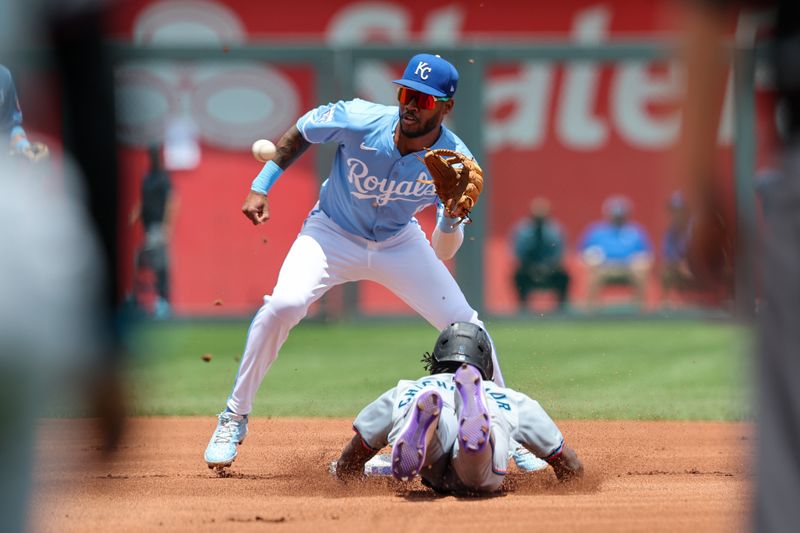 Jun 26, 2024; Kansas City, Missouri, USA; Kansas City Royals third base Maikel Garcia (11) reaches for the throw as Miami Marlins outfielder Jazz Chisholm Jr. (2) dives into second base during the first inning at Kauffman Stadium. Mandatory Credit: William Purnell-USA TODAY Sports
