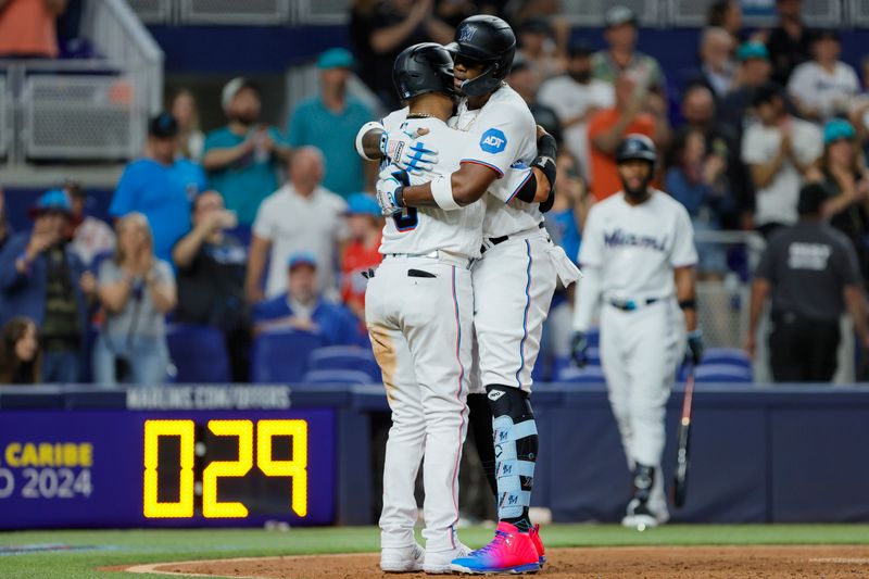 Jun 19, 2023; Miami, Florida, USA; Miami Marlins designated hitter Jorge Soler (12) hugs second baseman Luis Arraez (3) after hitting a two-run home run against the Toronto Blue Jays during the third inning at loanDepot Park. Mandatory Credit: Sam Navarro-USA TODAY Sports