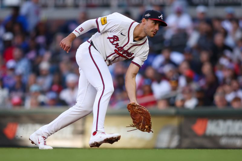 May 4, 2025; Atlanta, Georgia, USA; Atlanta Braves first baseman Matt Olson (28) fields a ground ball against the Los Angeles Dodgers in the second inning at Truist Park. Mandatory Credit: Brett Davis-Imagn Images