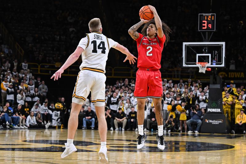 Jan 20, 2026; Iowa City, Iowa, USA; Rutgers Scarlet Knights guard Lino Mark (2) shoots the ball over Iowa Hawkeyes guard Bennett Stirtz (14) during the first half at Carver-Hawkeye Arena. Mandatory Credit: Jeffrey Becker-Imagn Images