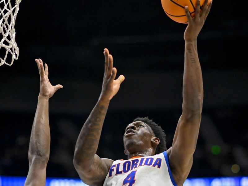 Mar 14, 2024; Nashville, TN, USA;  Florida Gators forward Tyrese Samuel (4) lays the ball up against the Georgia Bulldogs during the second half at Bridgestone Arena. Mandatory Credit: Steve Roberts-USA TODAY Sports