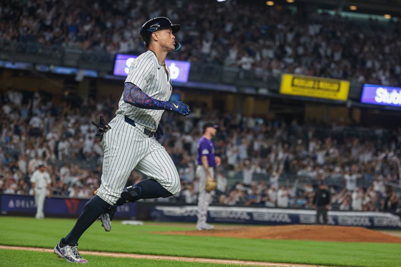 Aug 23, 2024; Bronx, New York, USA;  New York Yankees designated hitter Giancarlo Stanton (27) hits a solo home run during the fourth inning against Colorado Rockies starting pitcher Kyle Freeland (21) at Yankee Stadium. Mandatory Credit: Vincent Carchietta-USA TODAY Sports